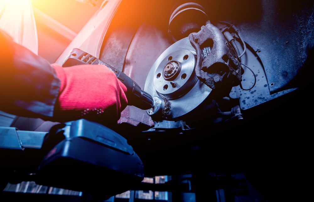 A Person is Working on a Brake Disc on a Car — Beenleigh Bearings in Beenleigh, QLD