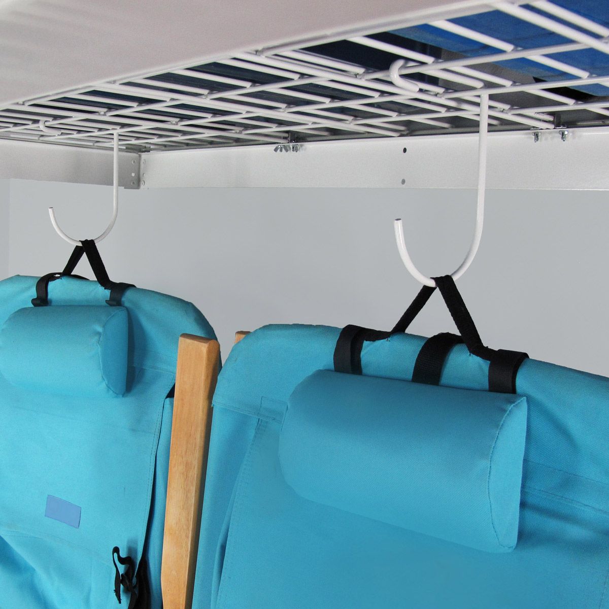 Two blue chairs are hanging from hooks under a ceiling