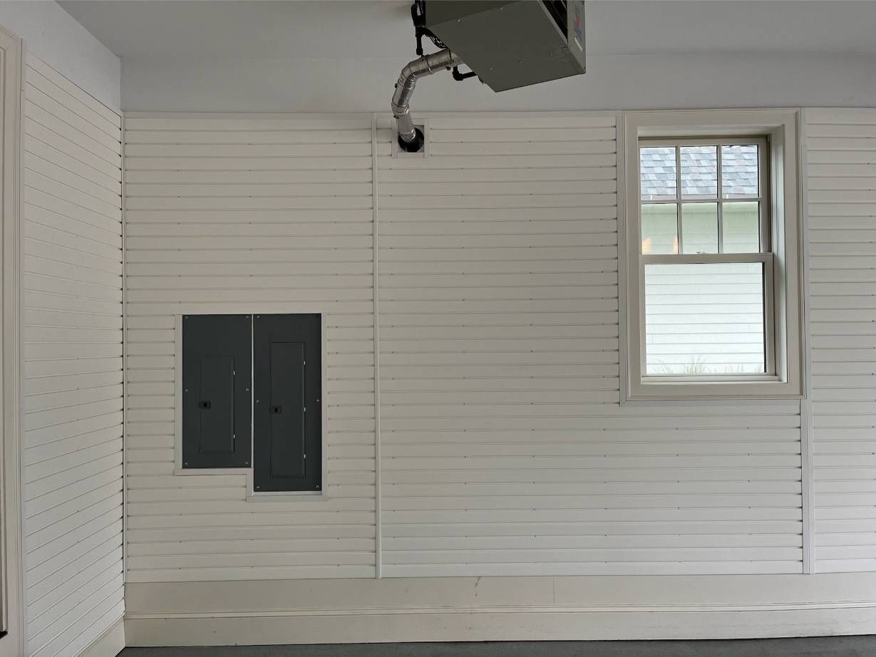 An empty room with white walls and a window.