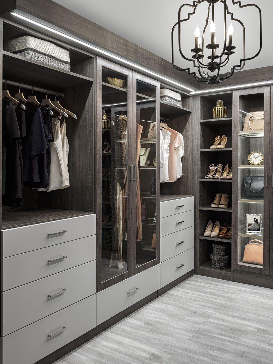 a walk in closet filled with lots of clothes and shoes .