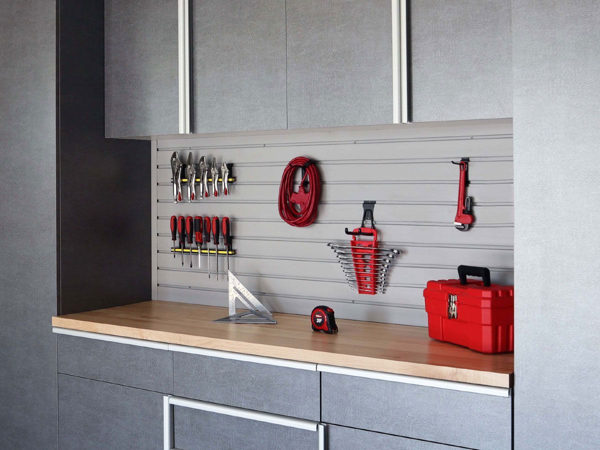 a red toolbox is sitting on a workbench in a garage .