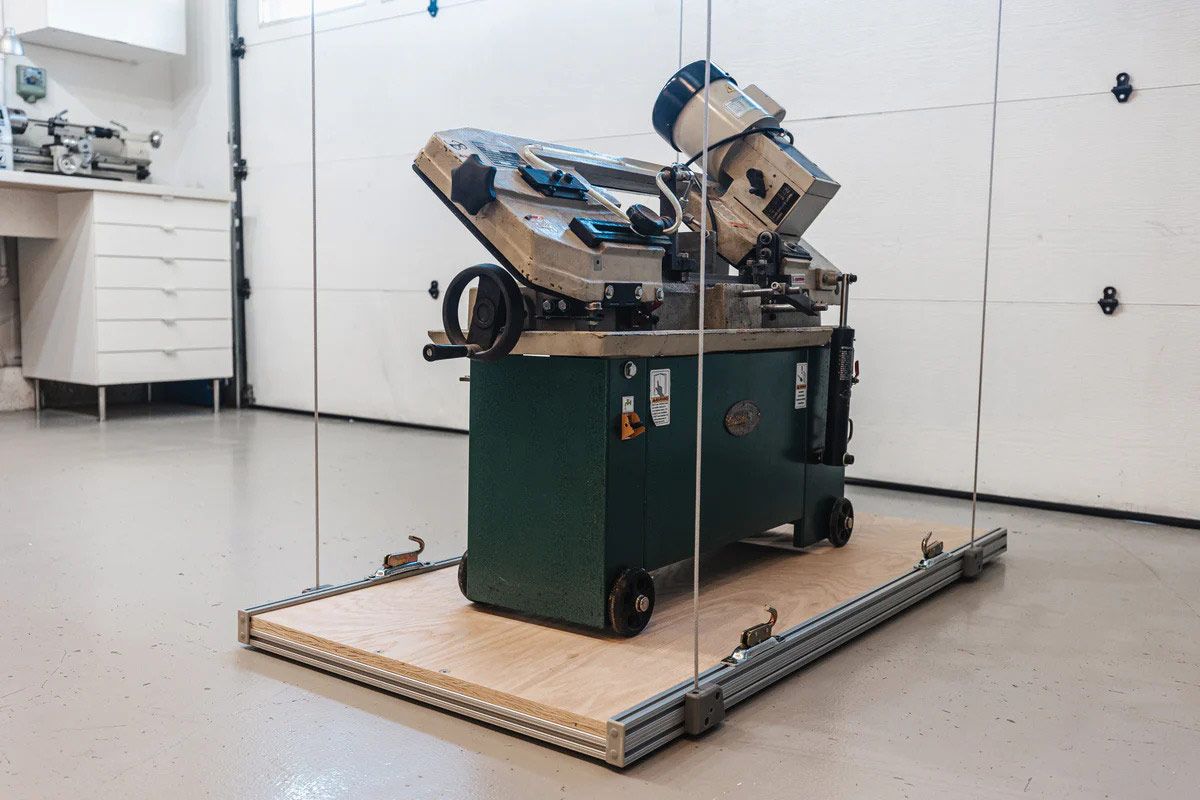 A machine is sitting on a wooden platform in a garage