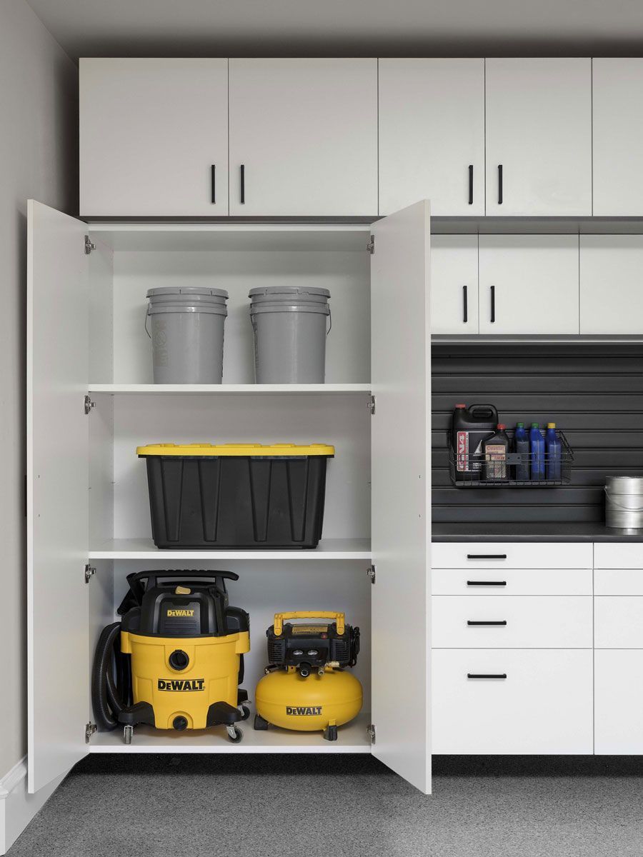 A dewalt vacuum cleaner is sitting inside of a cabinet