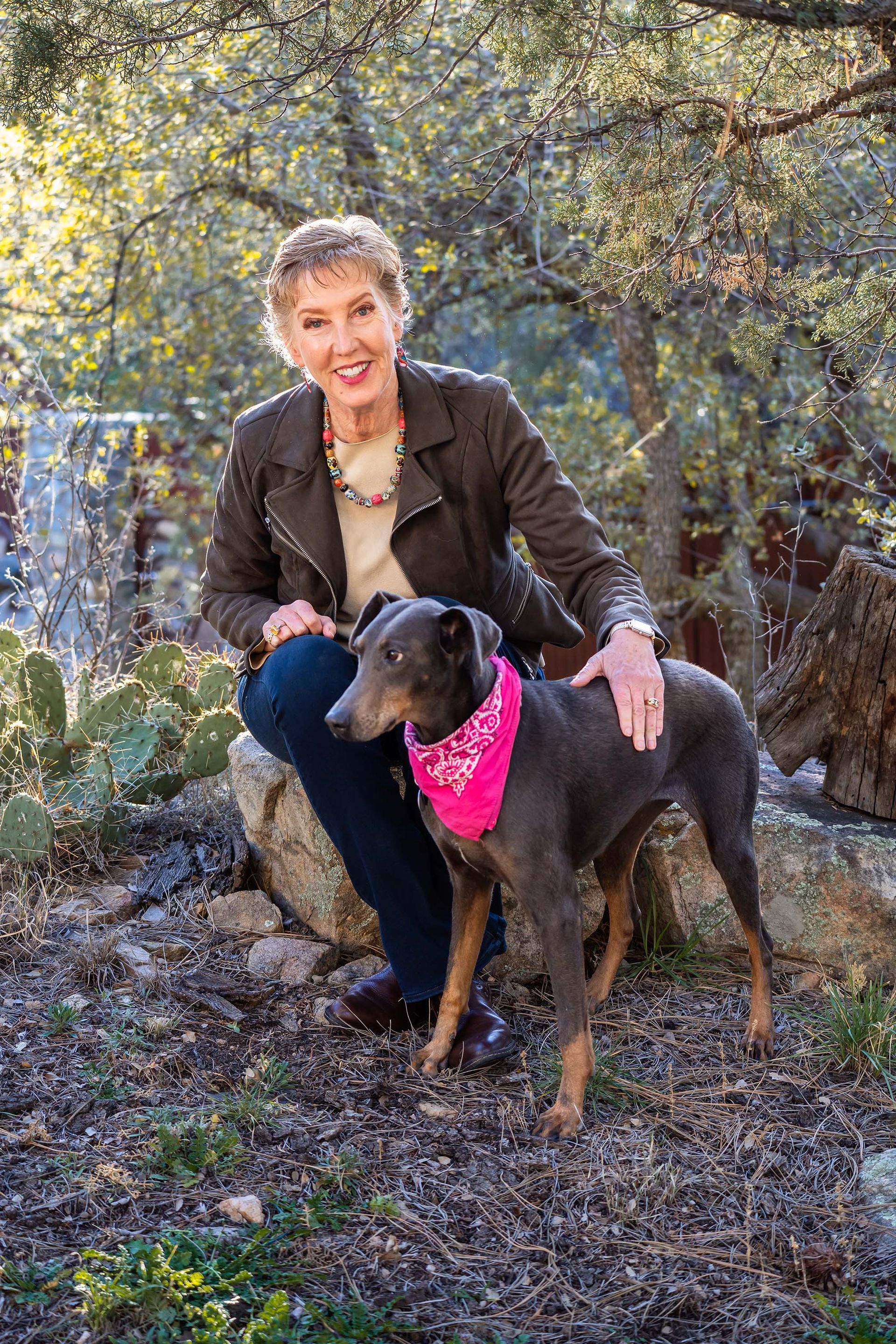 woman walking with dog in open field