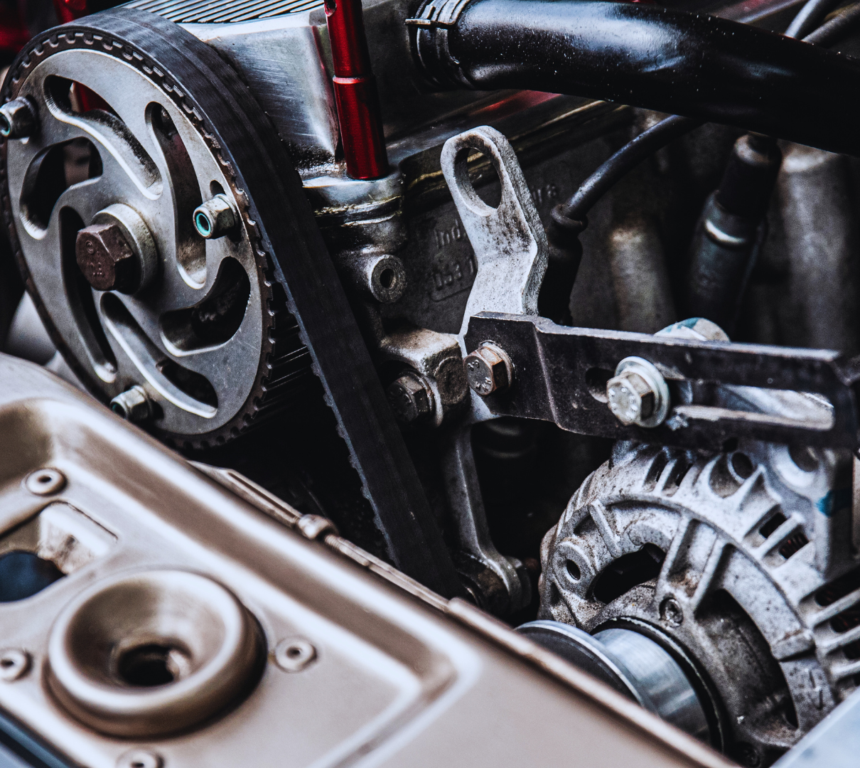 A close up of a car engine with the hood open