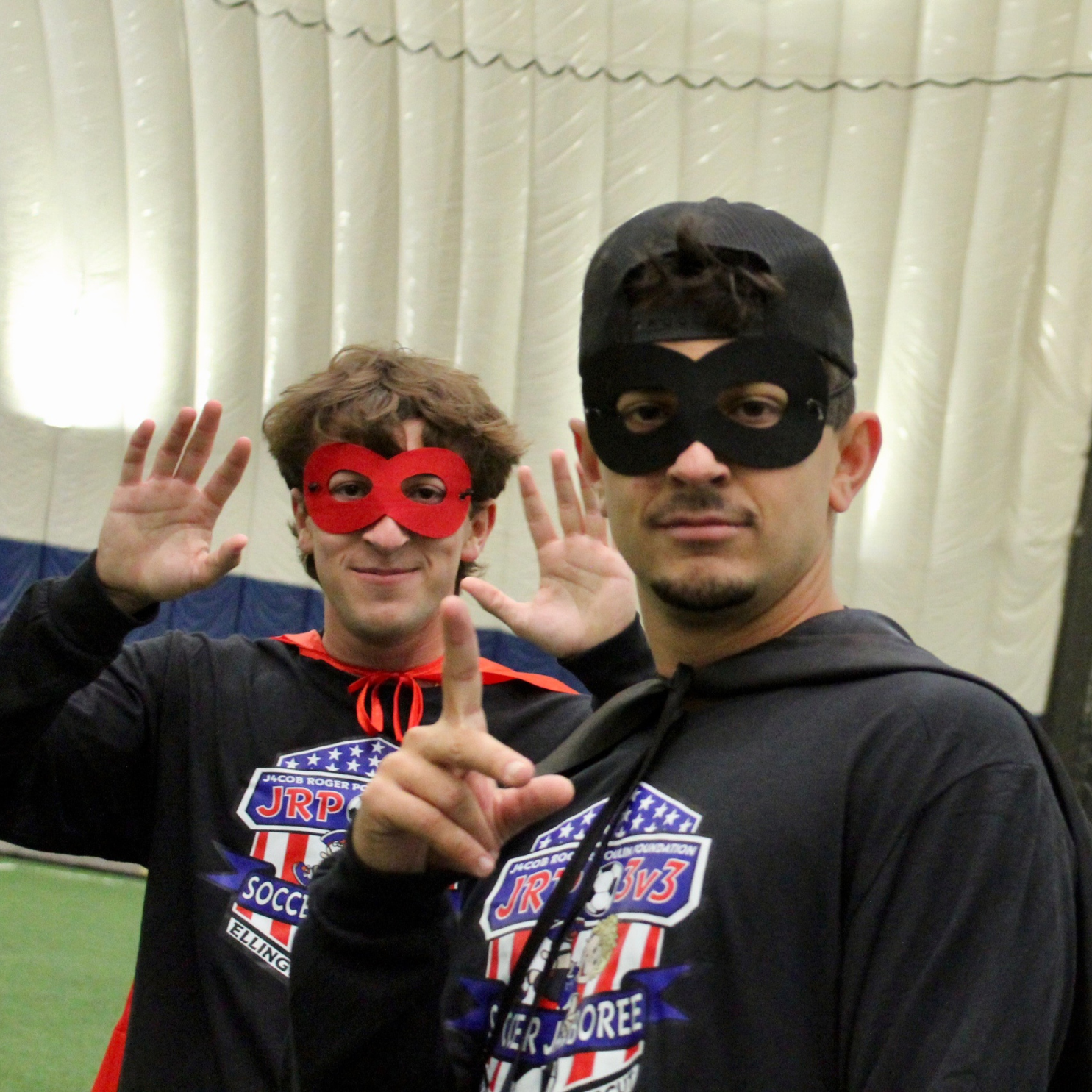 GroClix founder Nick Desrocher and Kevin Desrocher dressed as superheroes at the Jacob Roger Poulin Foundation Soccer Tournament, wearing capes and masks to bring smiles and remind players of the event’s purpose and community spirit.