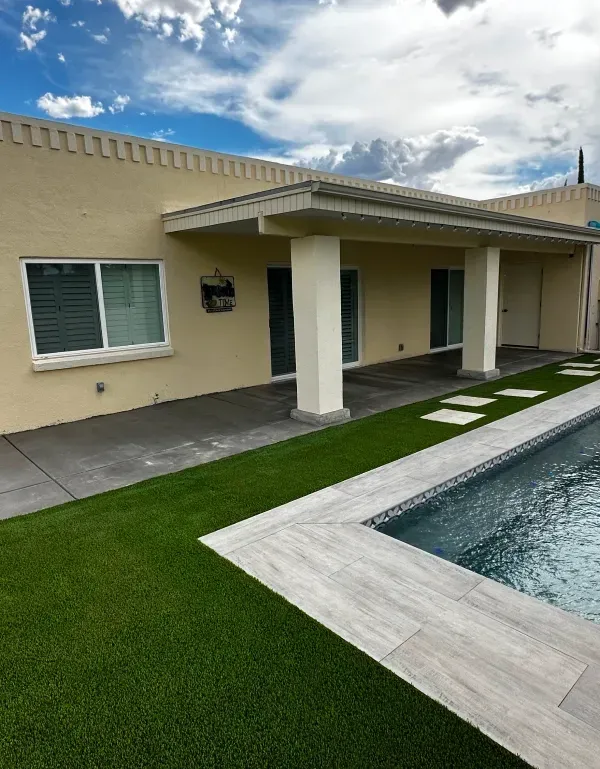 A house with a swimming pool in front of it