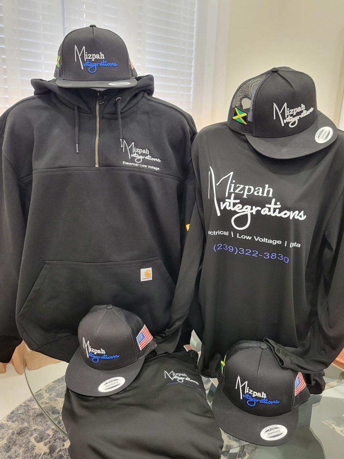 A group of black shirts and hats are sitting on a table.