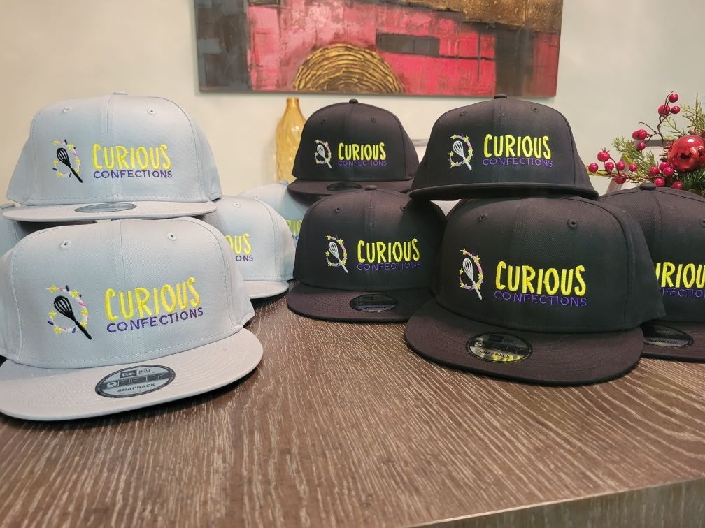 A bunch of curious hats are sitting on a table.