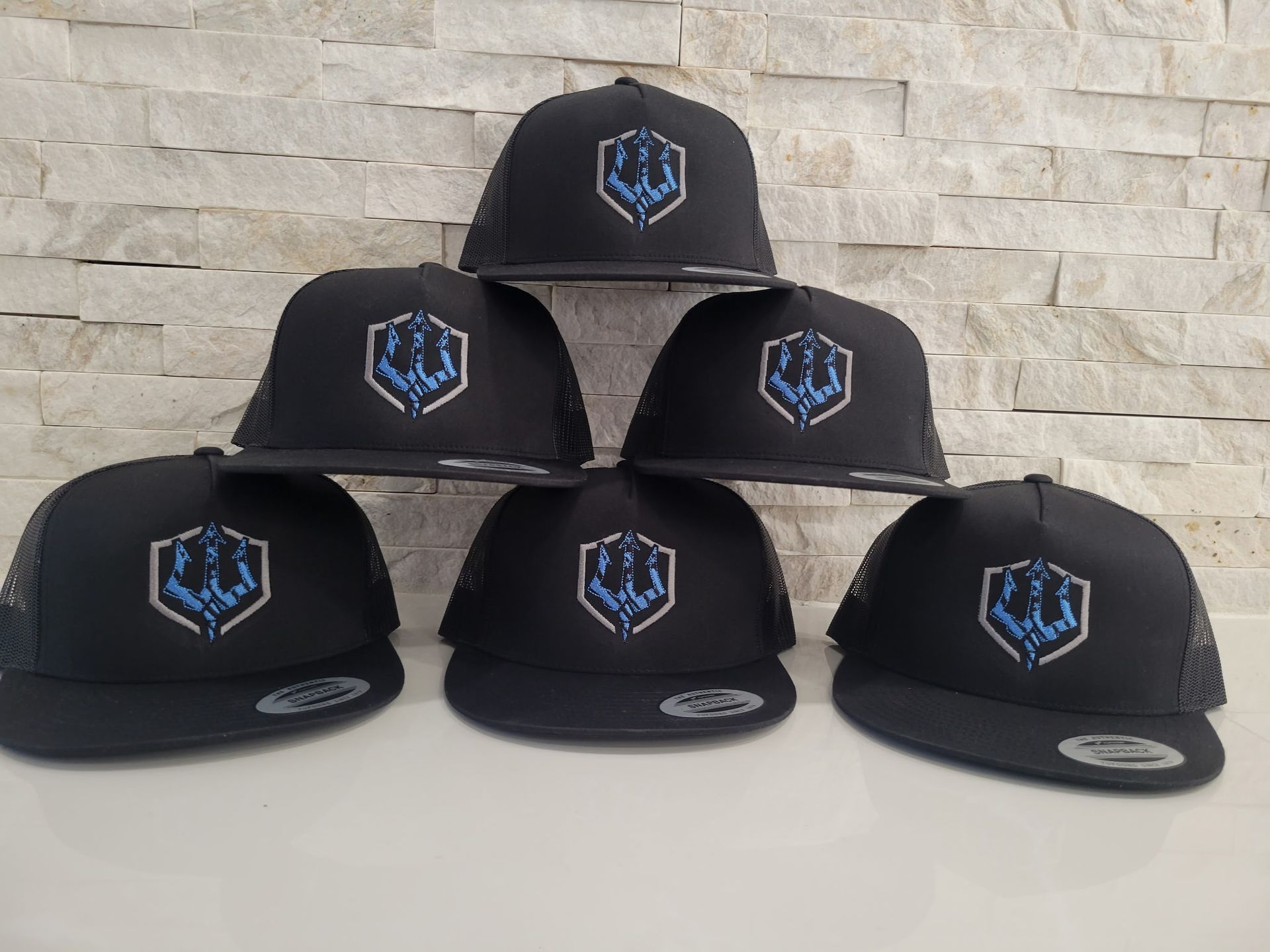 A group of black hats are stacked on top of each other.