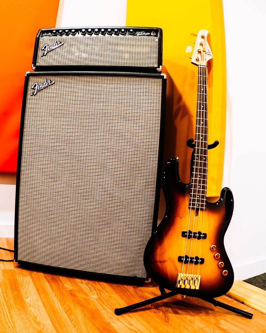 A girl holding a bass guitar during bass guitar lessons