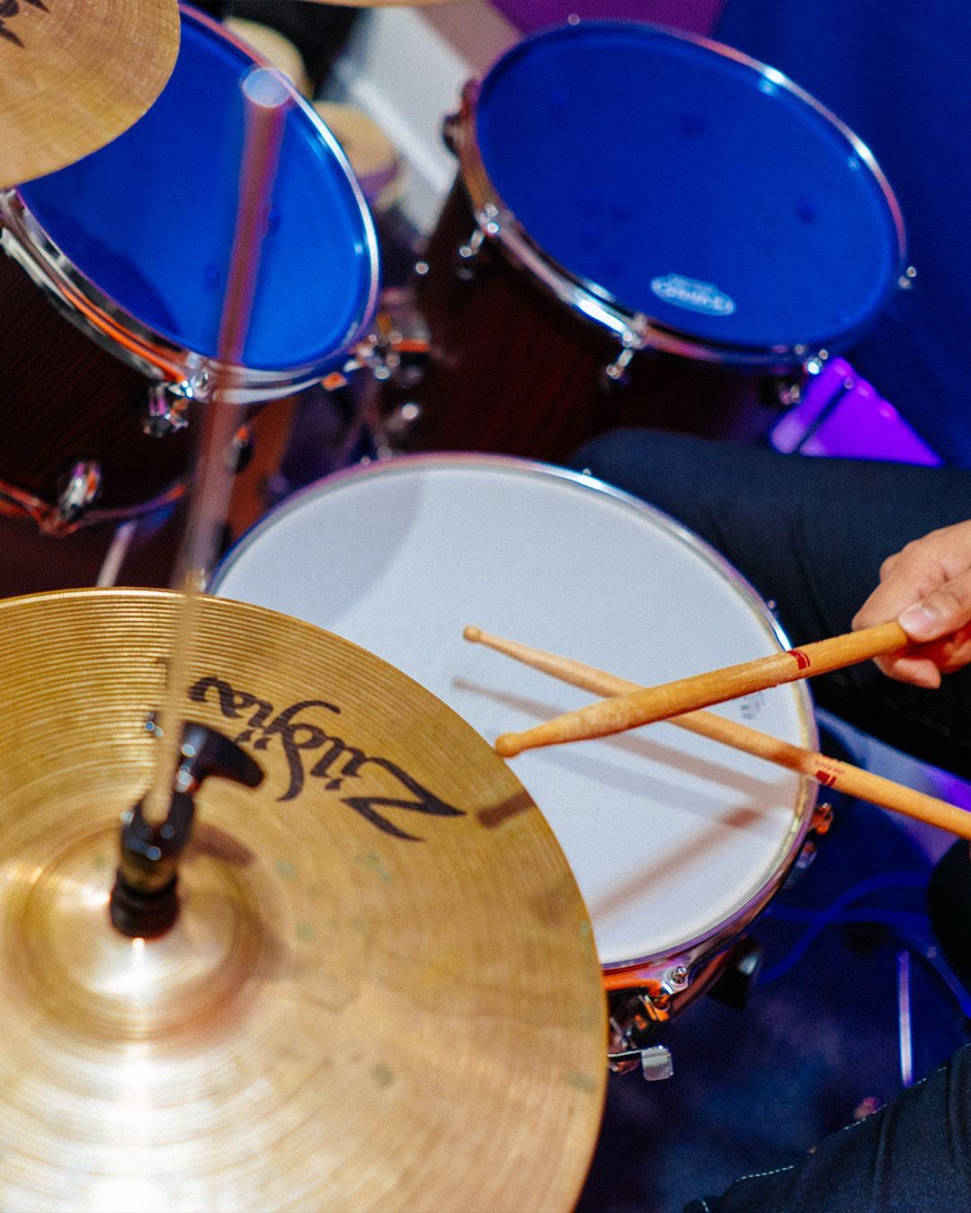 Guy playing drums during a concert