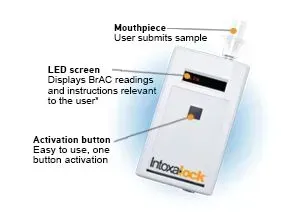 An Intoxalock breathalyzer device. Shows mouthpiece, LED screen, and activation button.