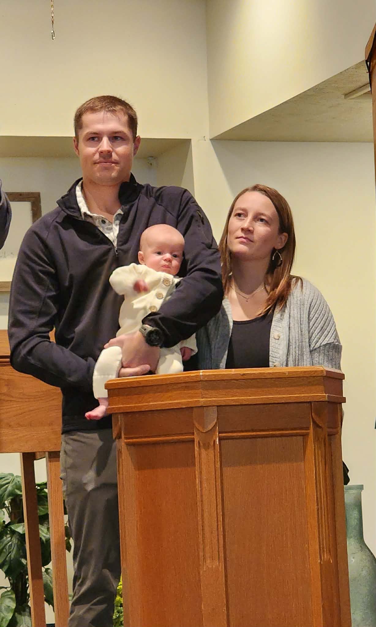 Christmas Eve candlelight service flyer: Angel, star, buildings, text on a dark blue background.