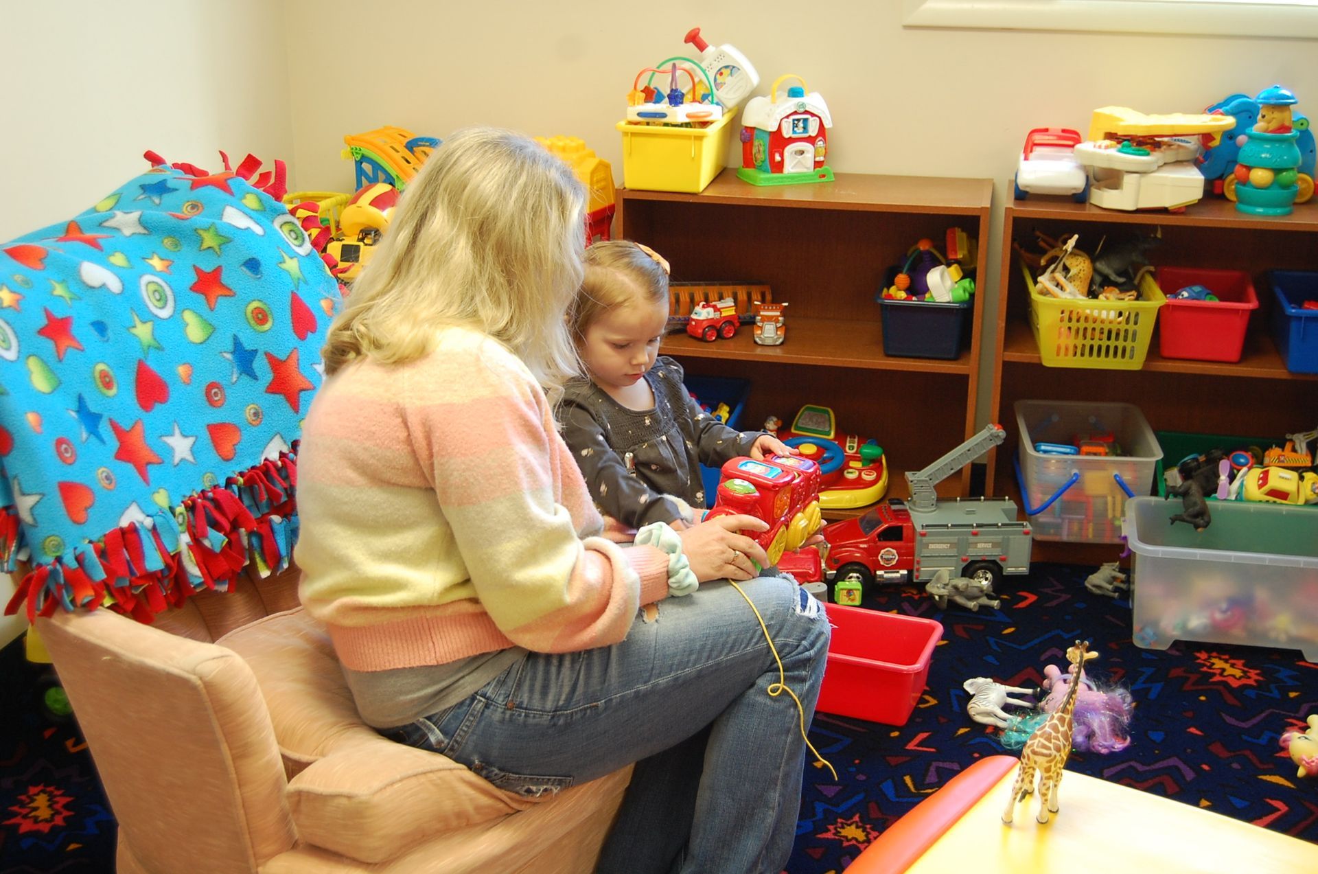 A collage of children playing with toys and a woman holding a baby