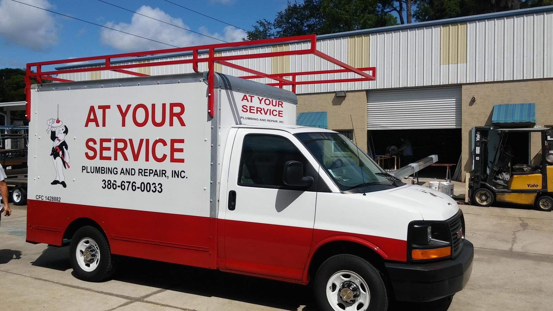 A red and white van that says at your service