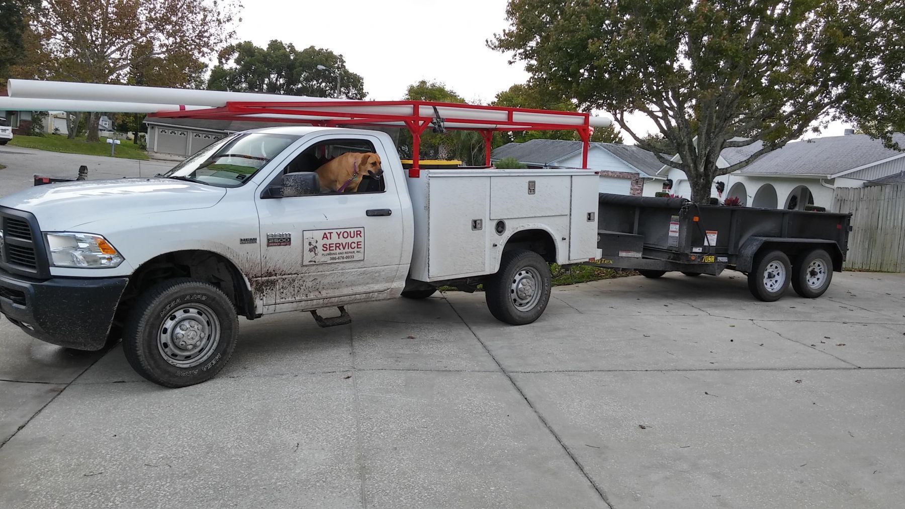 A white truck with a trailer attached to it