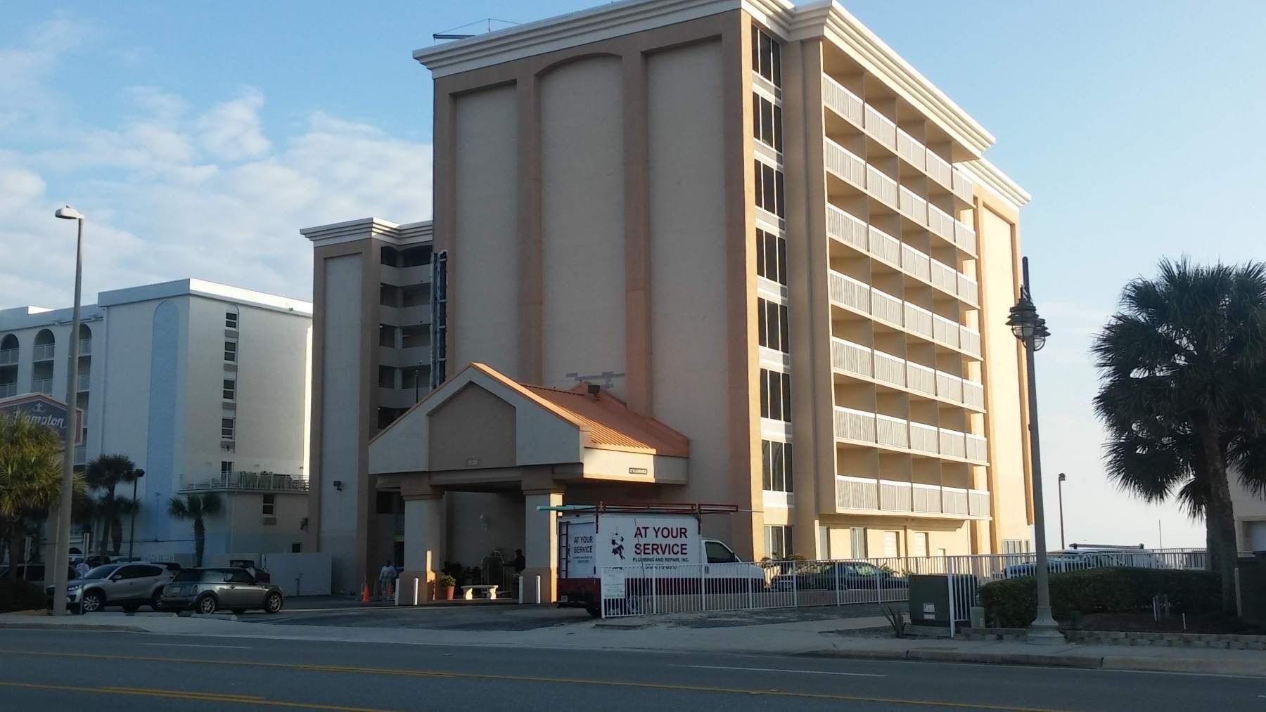 A large building with a white van parked in front of it
