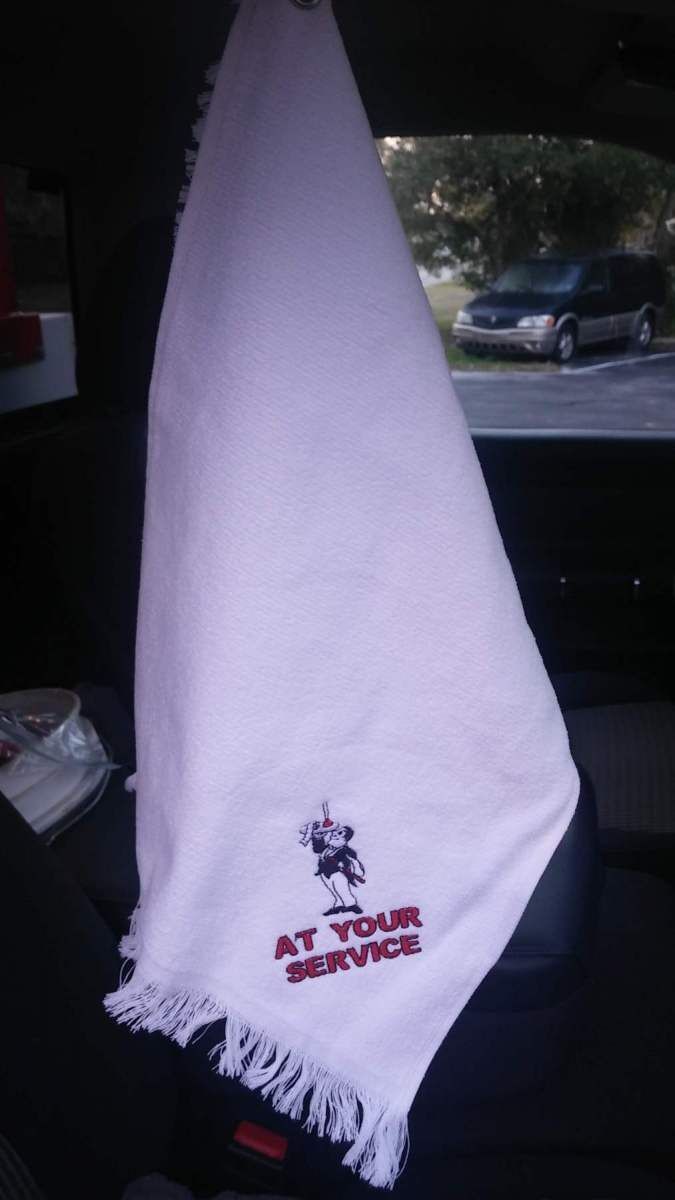 A white towel that says at your service on it