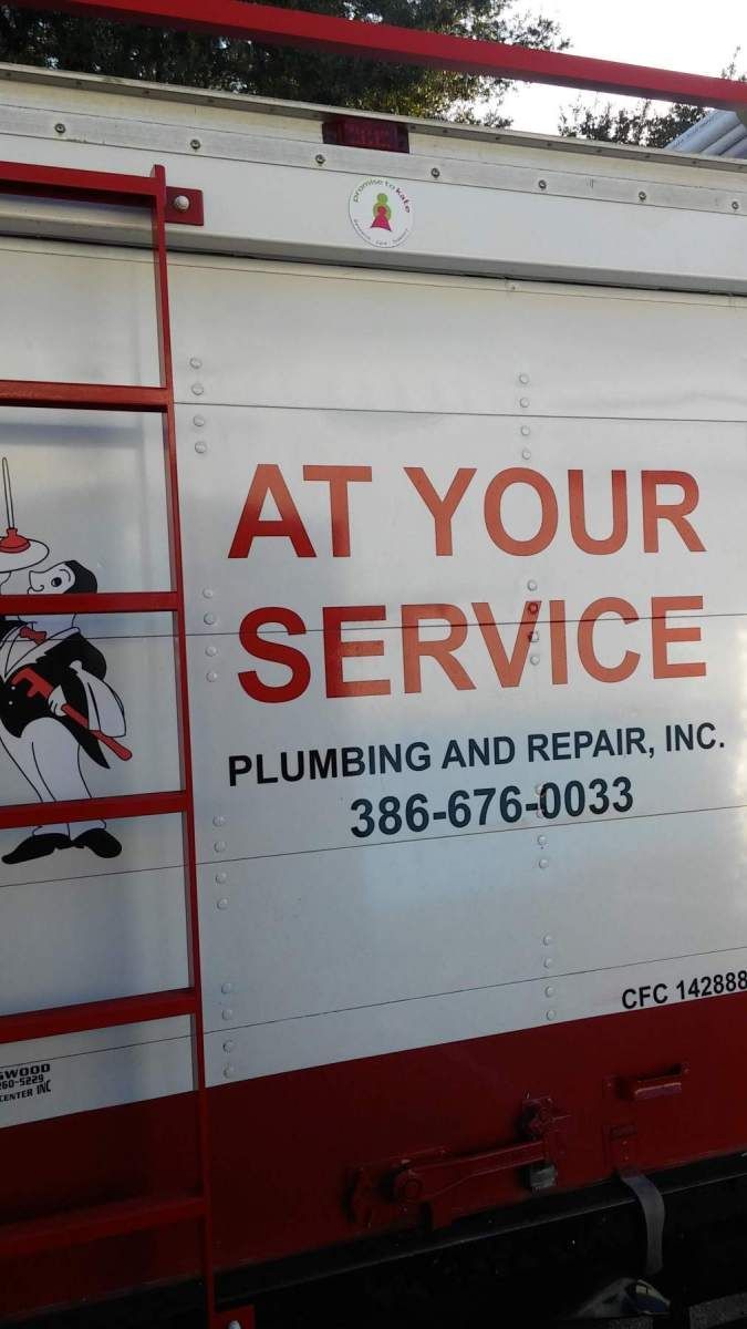 A truck that says at your service plumbing and repair inc