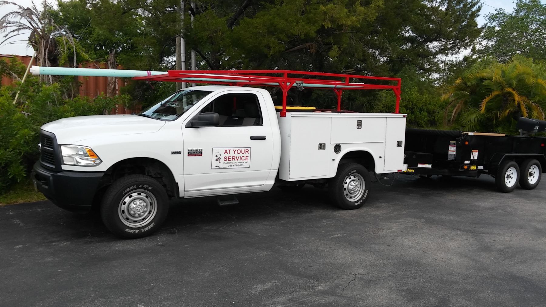 A white truck with a trailer attached to it