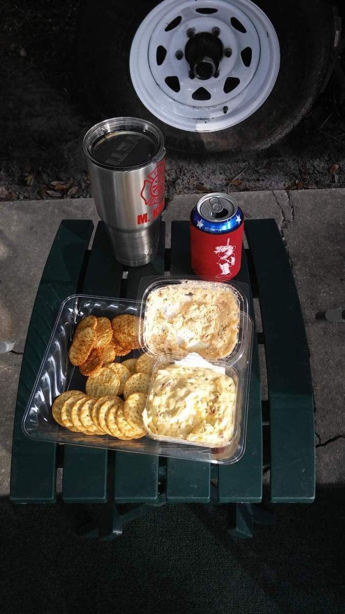A table with a plate of food and a can of soda on it.