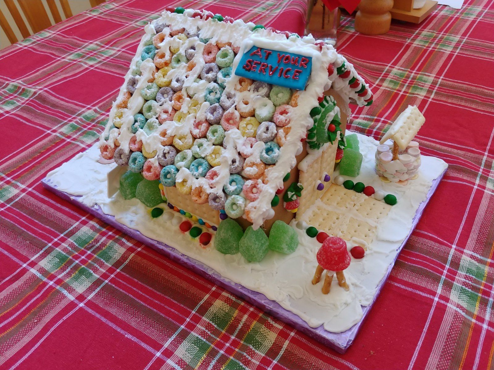 A gingerbread house made out of cereal is on a table