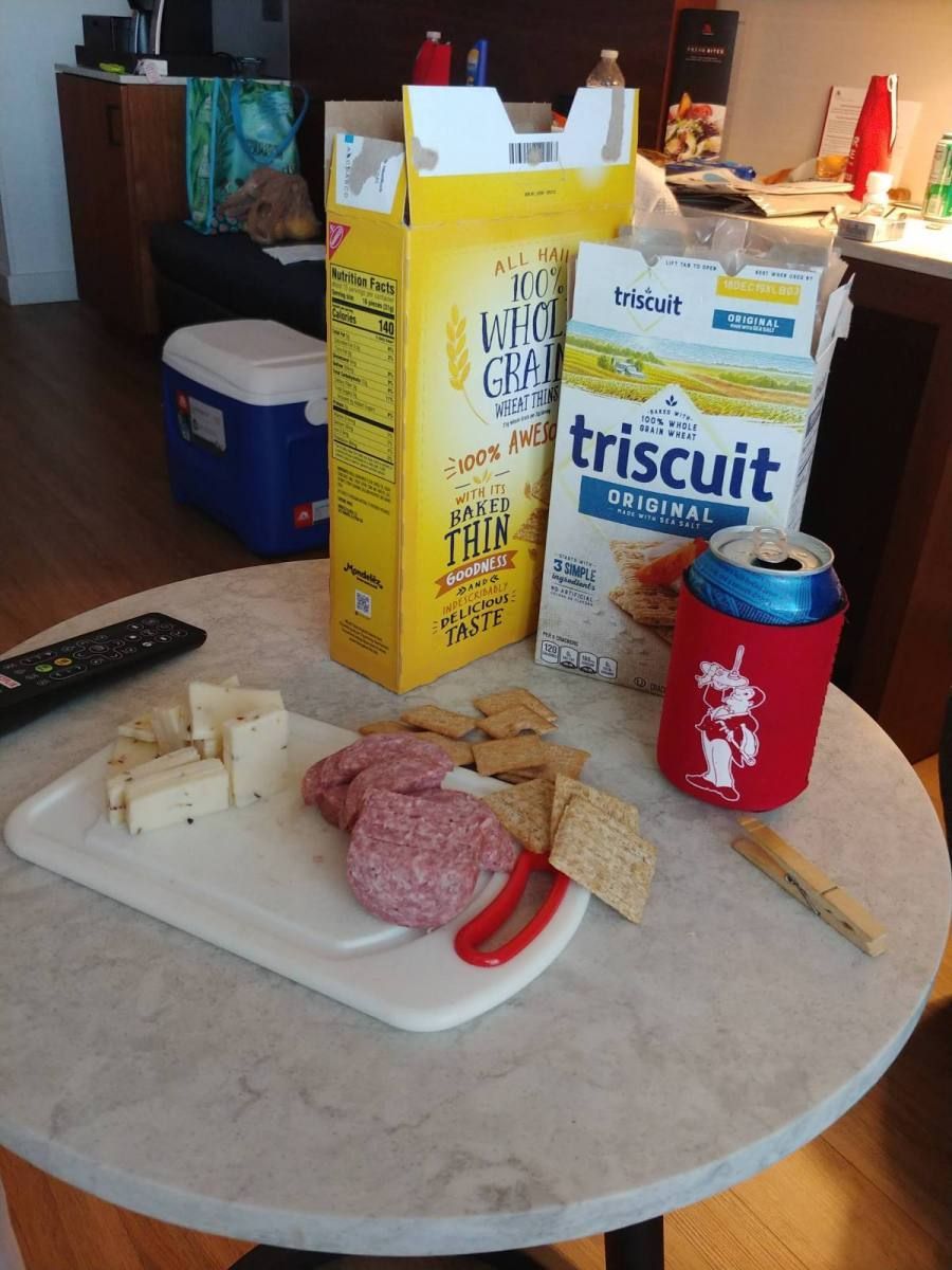 A box of triscuit sits on a table next to a box of milk