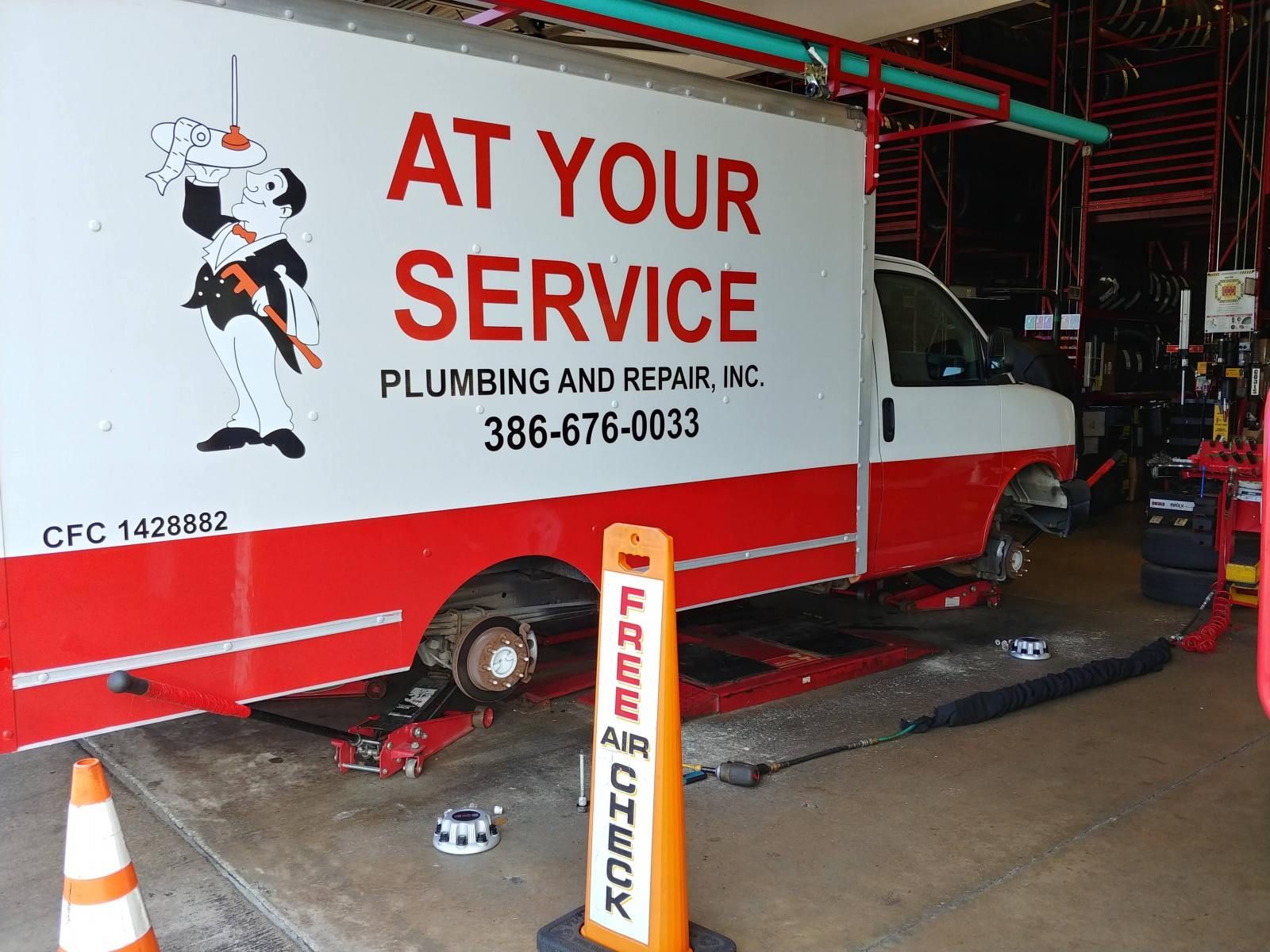 A red and white truck that says at your service
