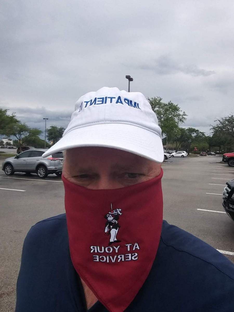 A man wearing a white hat and a red bandana