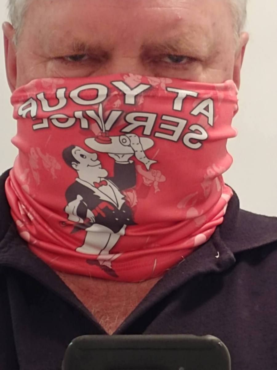 A man wearing a scarf that says auoy ta on it