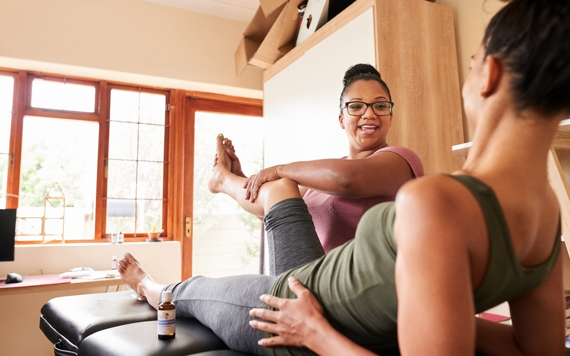 Examining Woman Leg — Florence, KY — Broeg Chiropractic And Nutrition Center