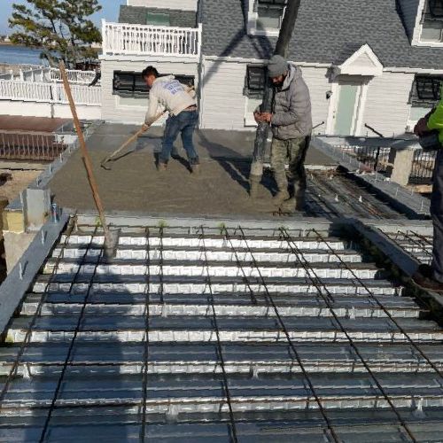 Two Men Are Working On A Concrete Floor — Ocean City, NJ — Padula Masonry