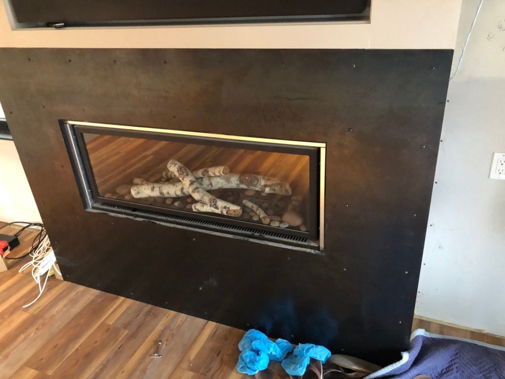 A fireplace with a television above it in a living room.