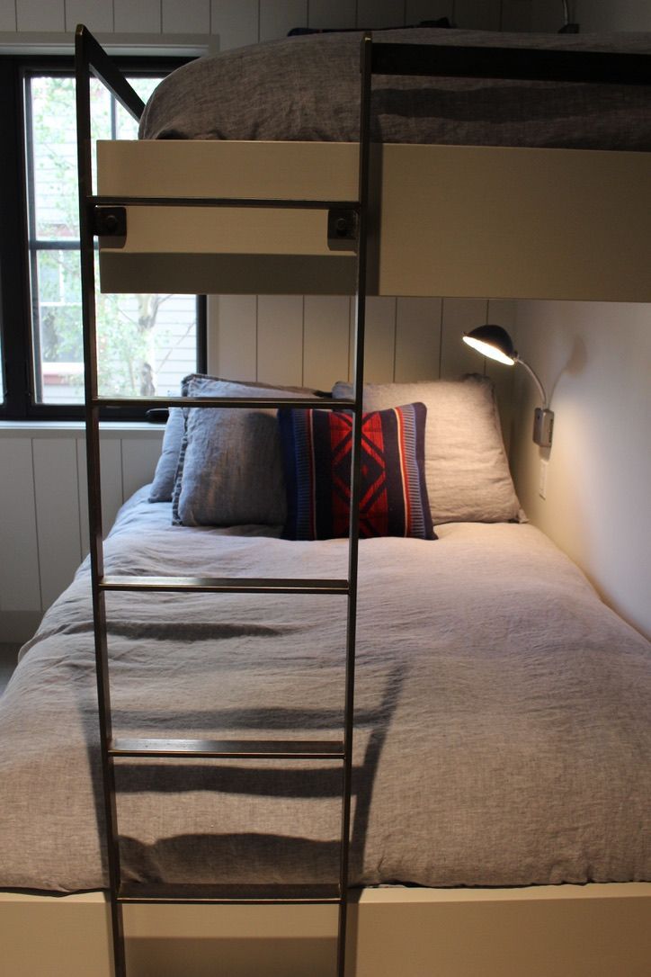 A bunk bed with a ladder leading up to it