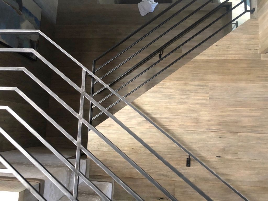 A staircase with a metal railing and wooden steps