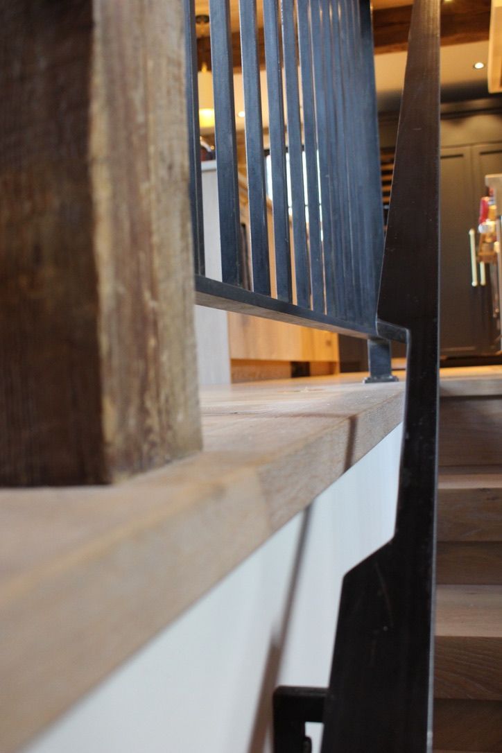 A staircase with a metal railing and wooden steps