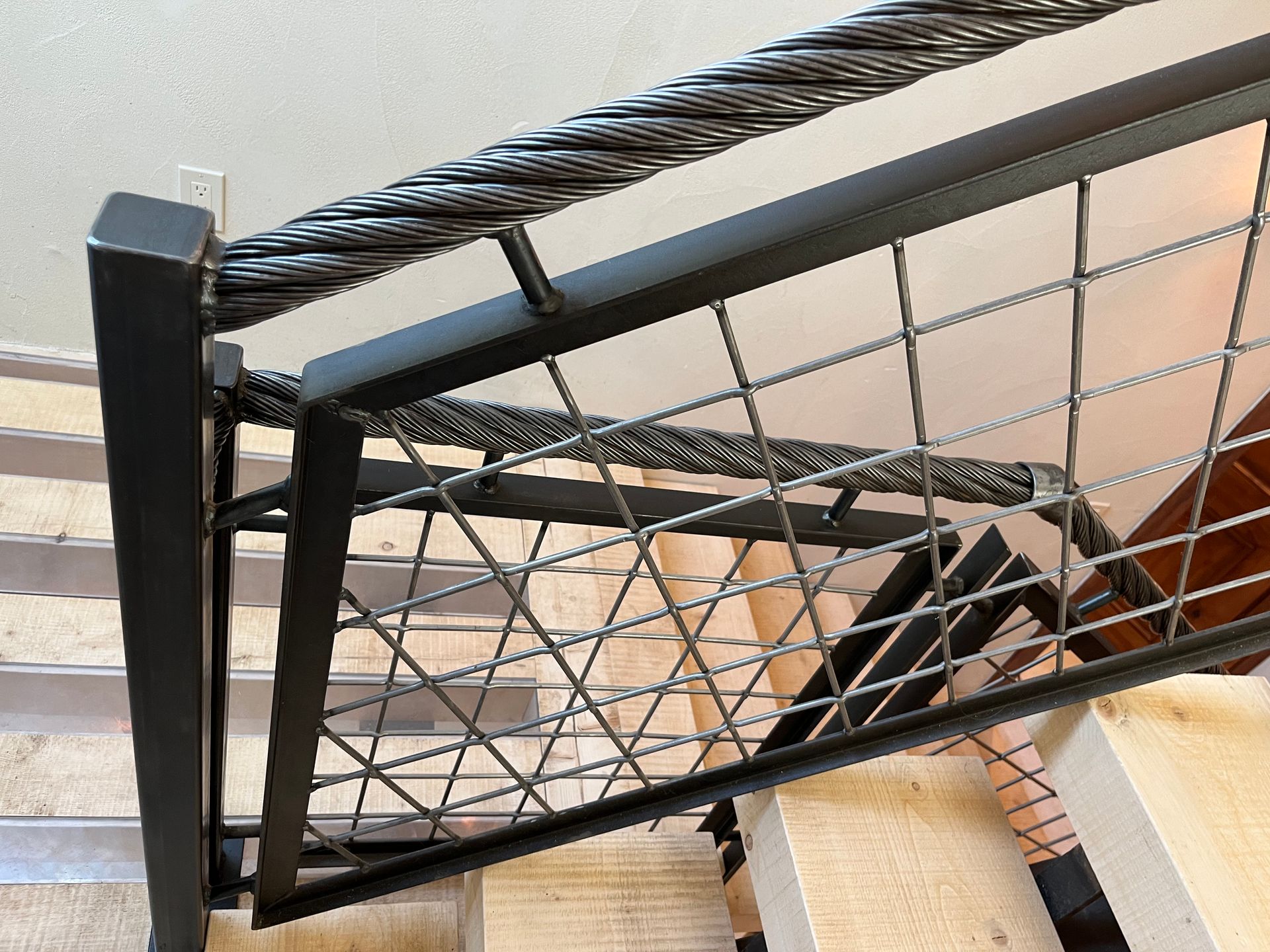 A close up of a metal railing on a set of stairs
