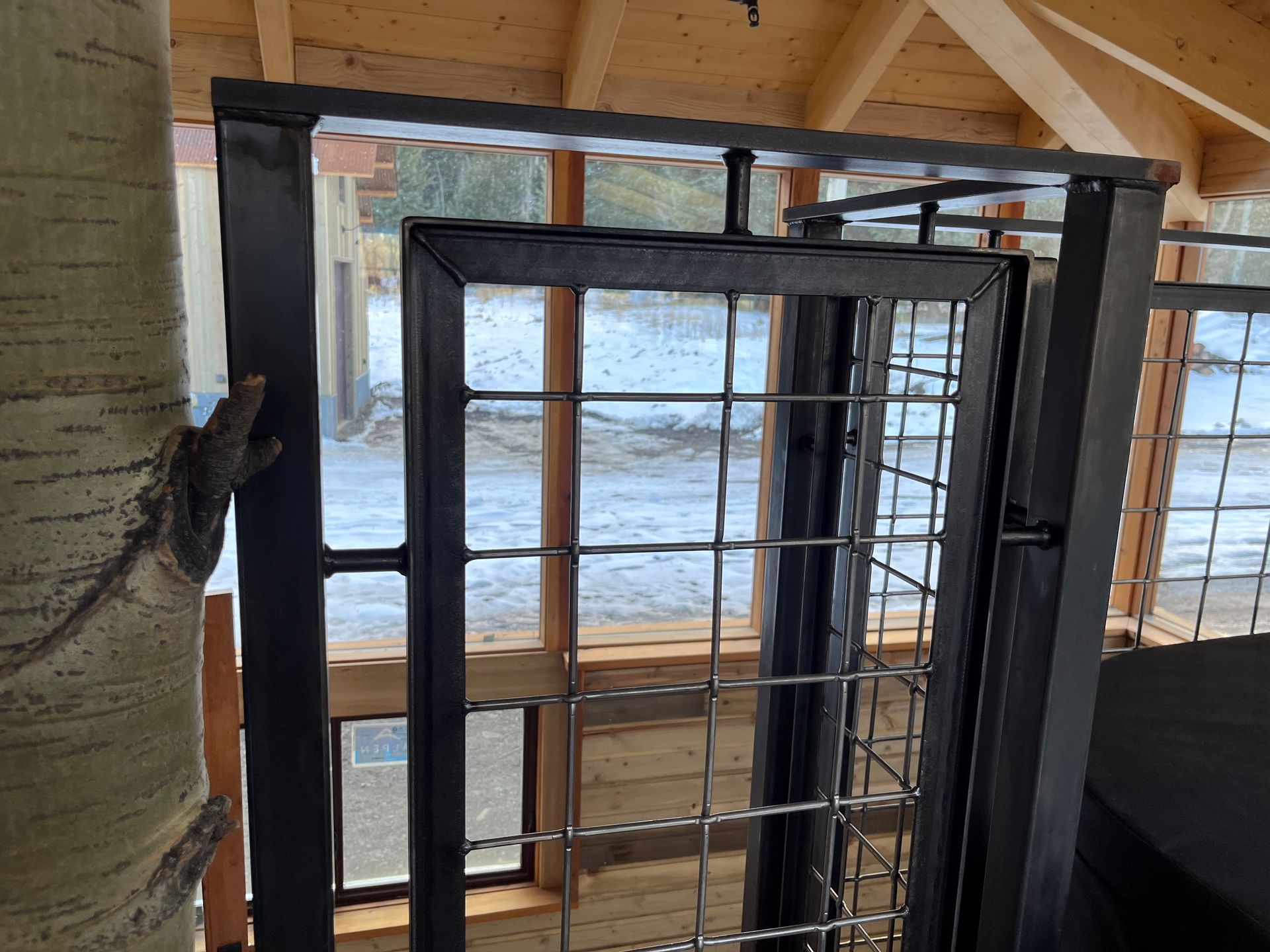 A wooden building with a metal fence and a window