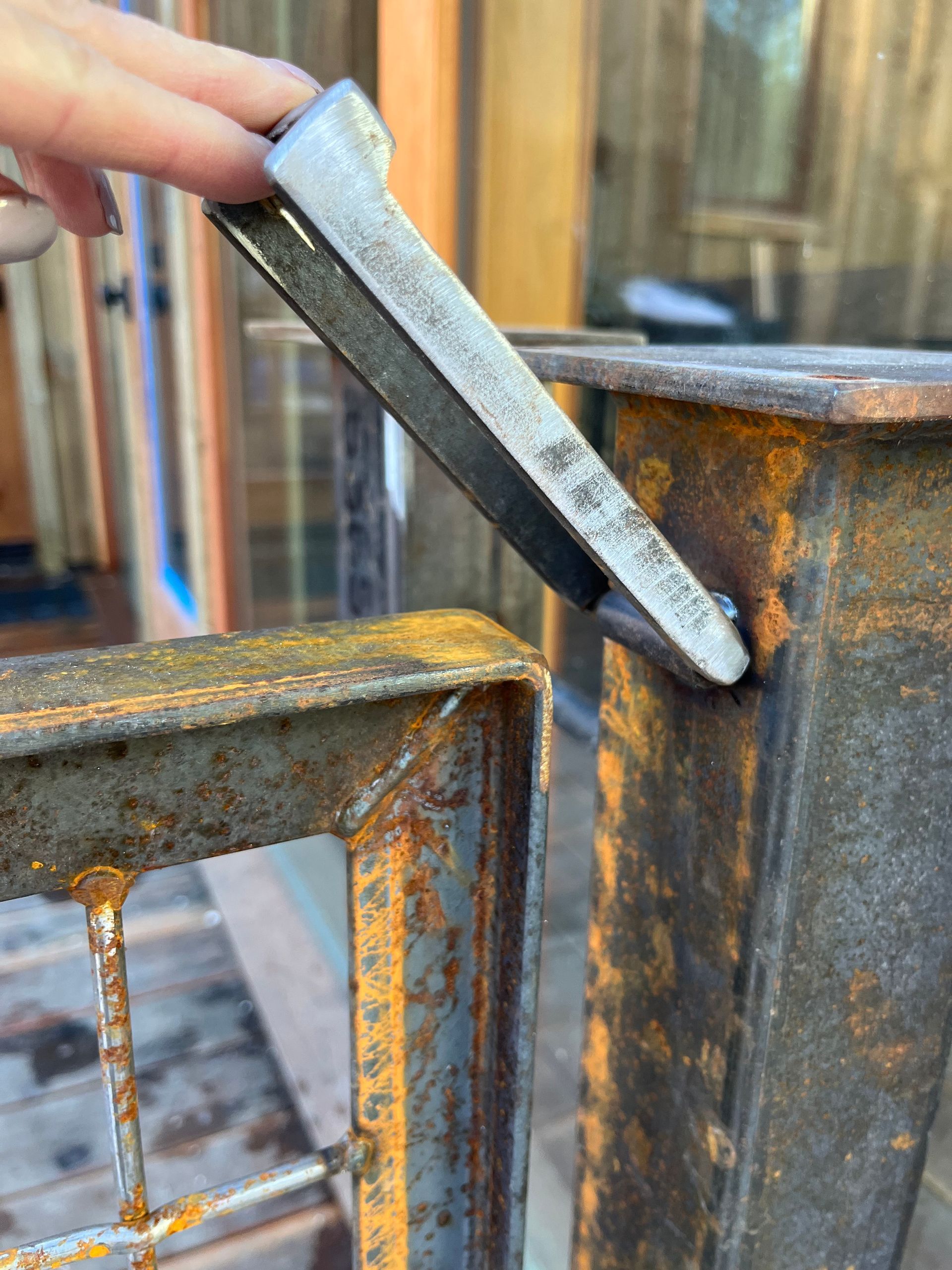 A close up of a person holding a piece of metal.