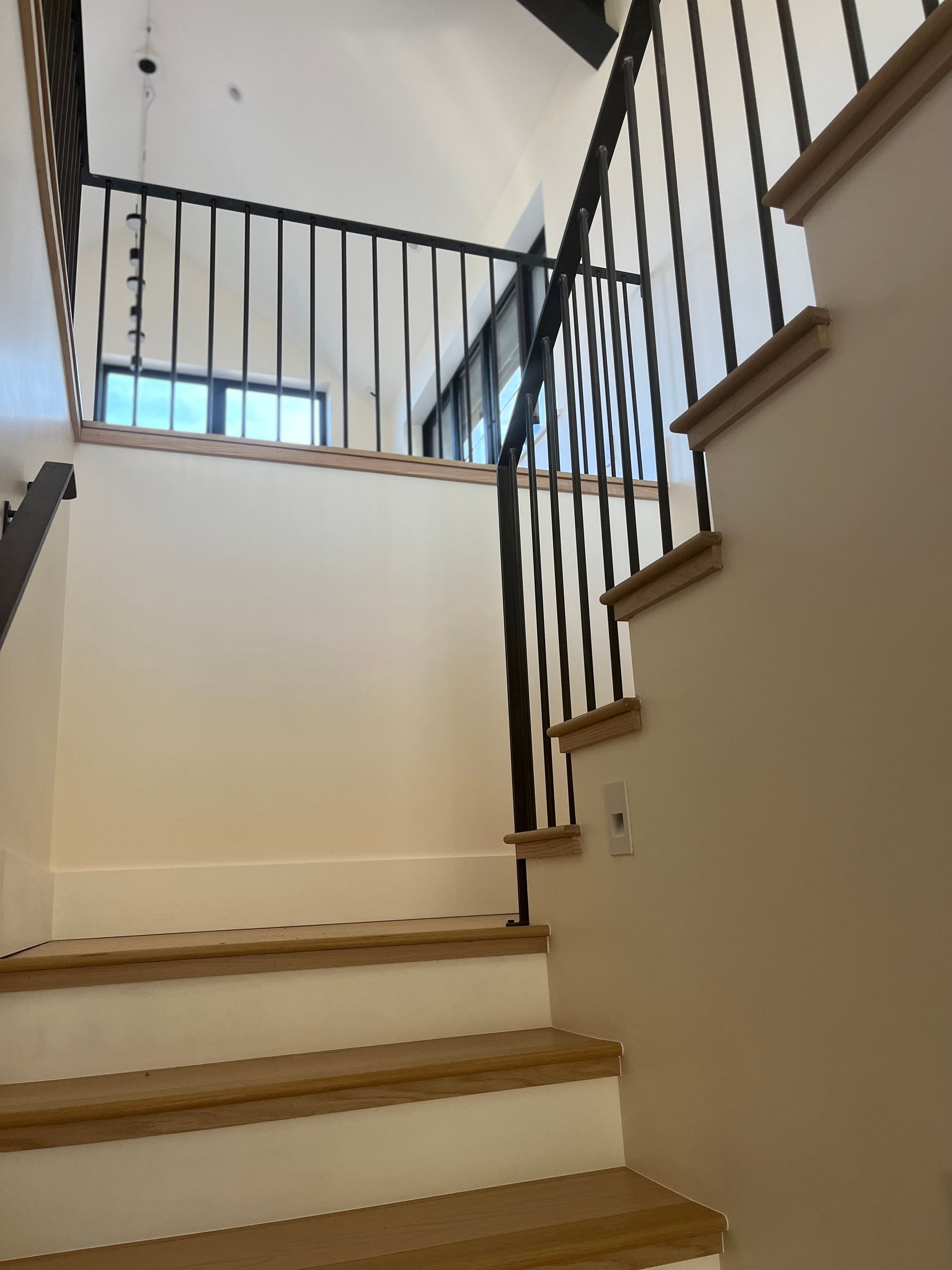 A staircase with wooden steps and a metal railing