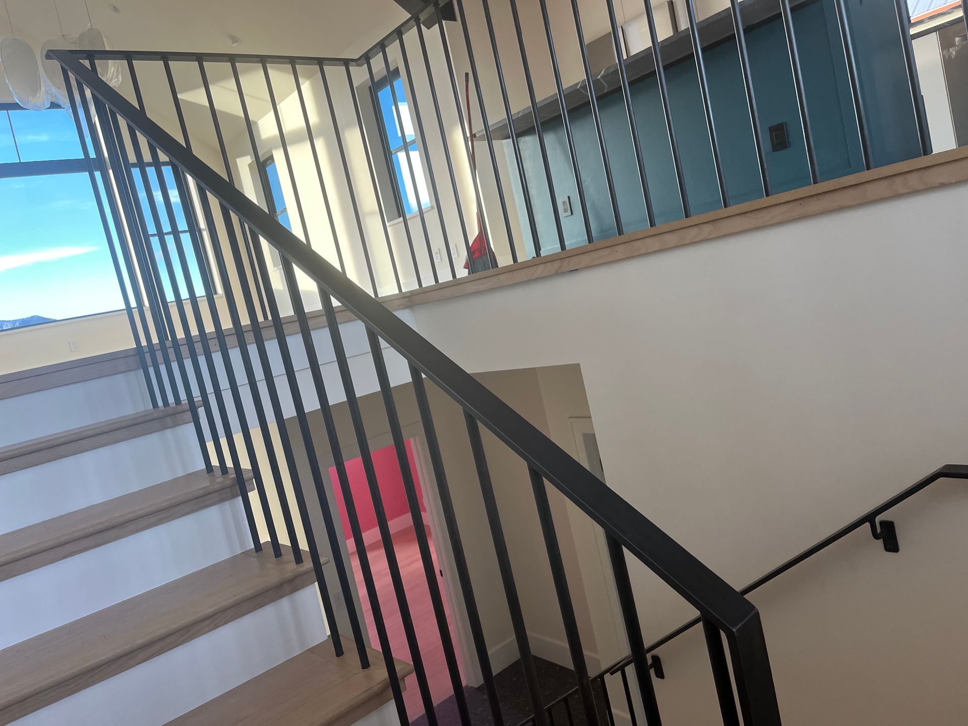 A close up of a staircase with a black railing