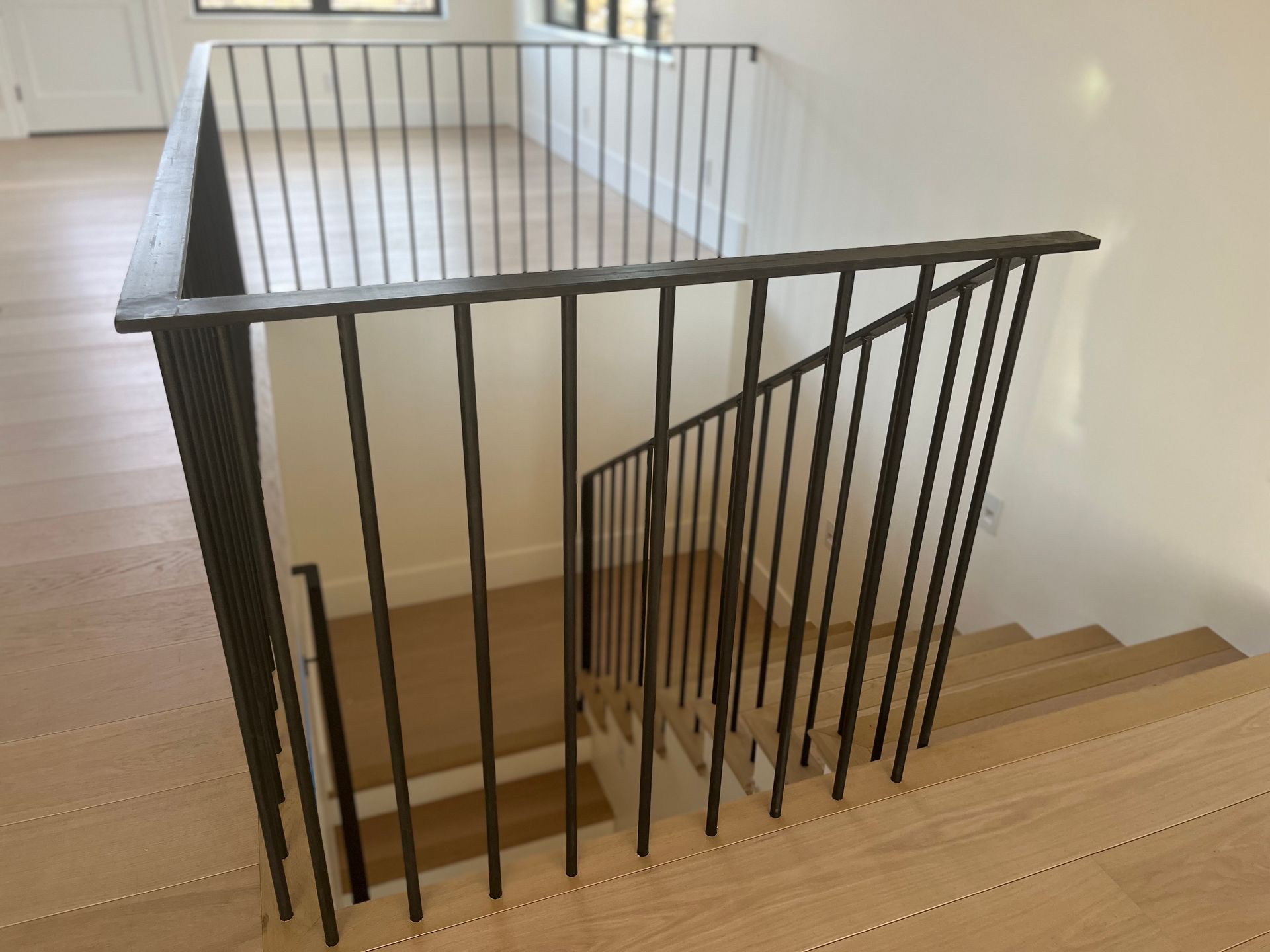 A staircase with a metal railing and wooden steps