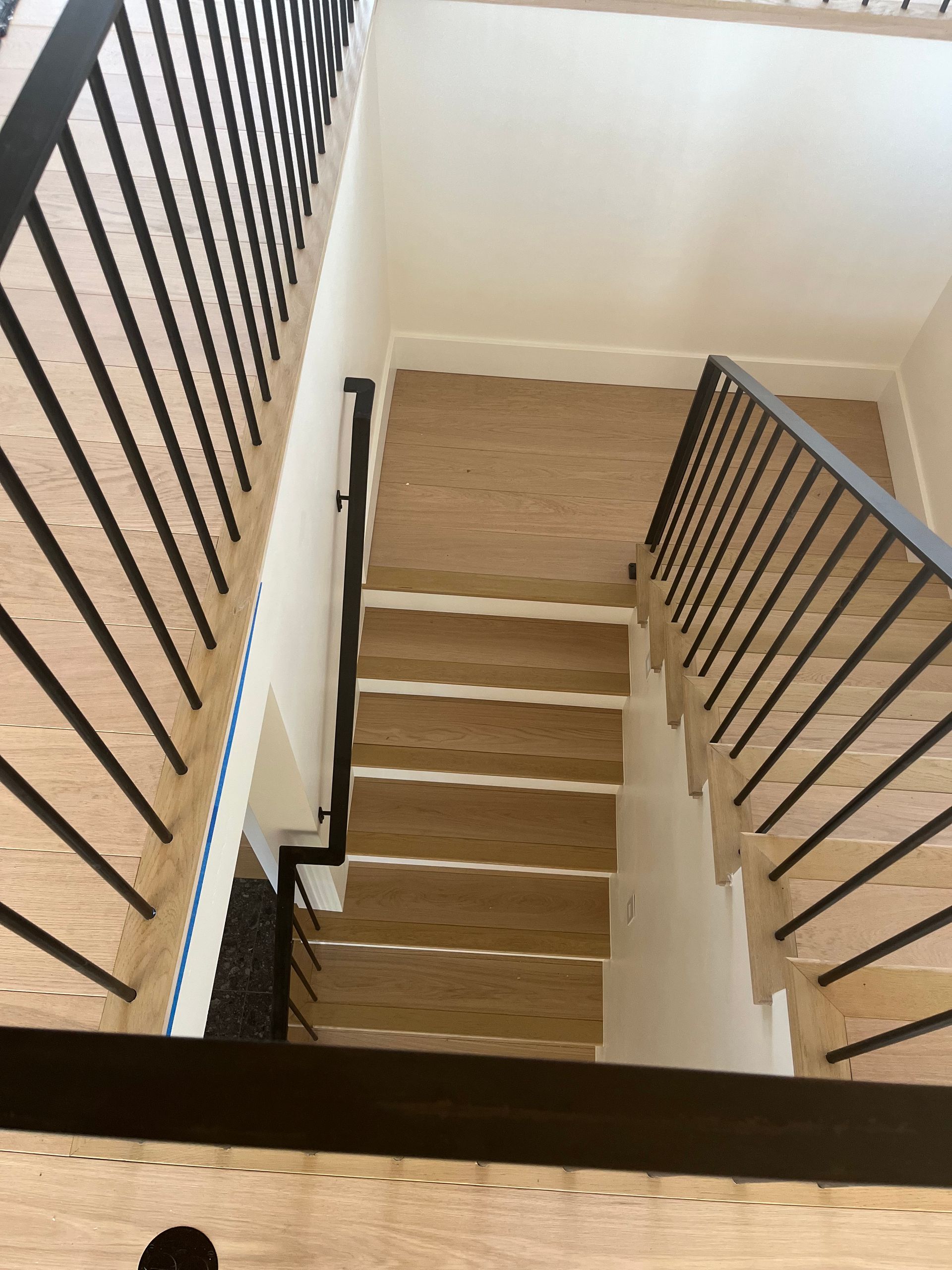 A staircase with wooden steps and a metal railing