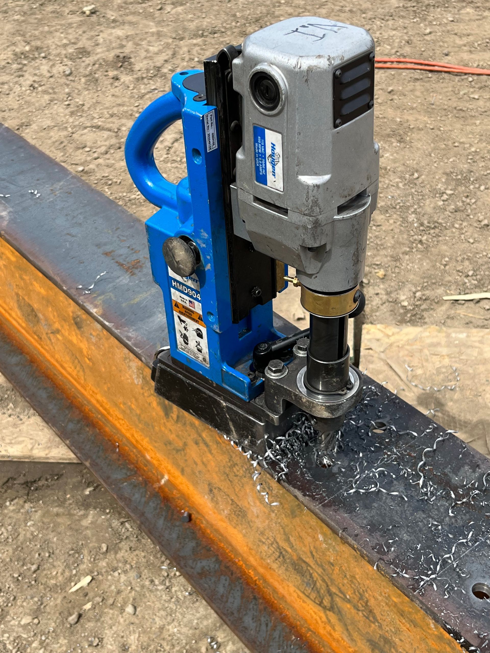 A machine is cutting a hole in a piece of metal.