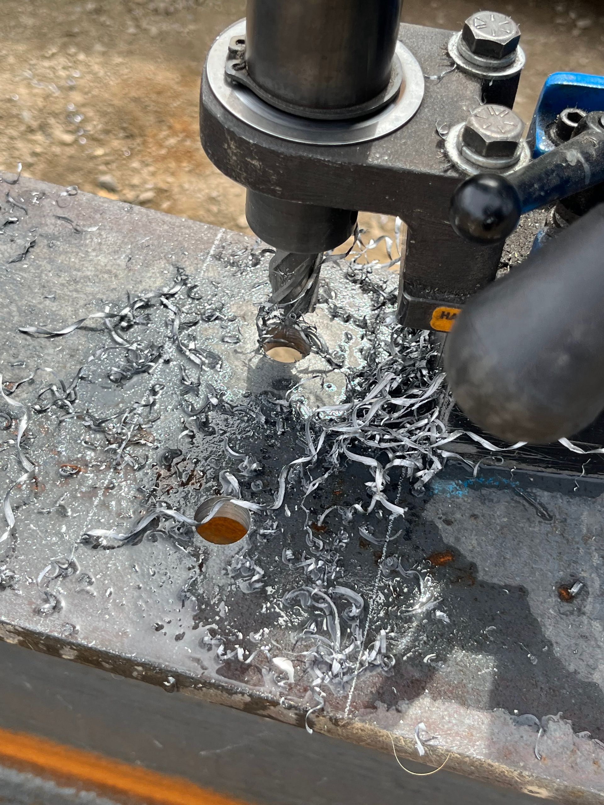A machine is cutting a hole in a piece of metal.