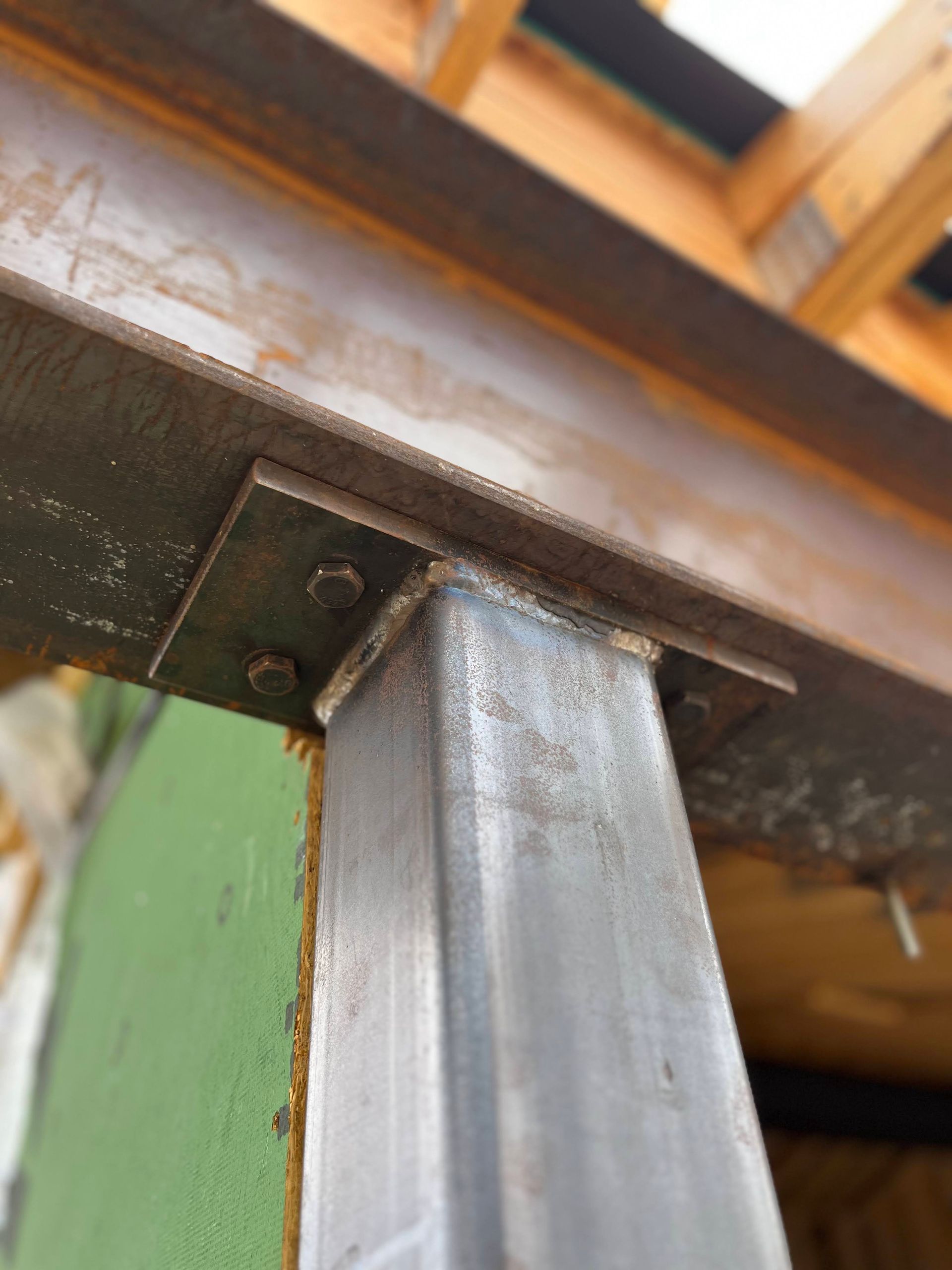A close up of a metal post with screws on it