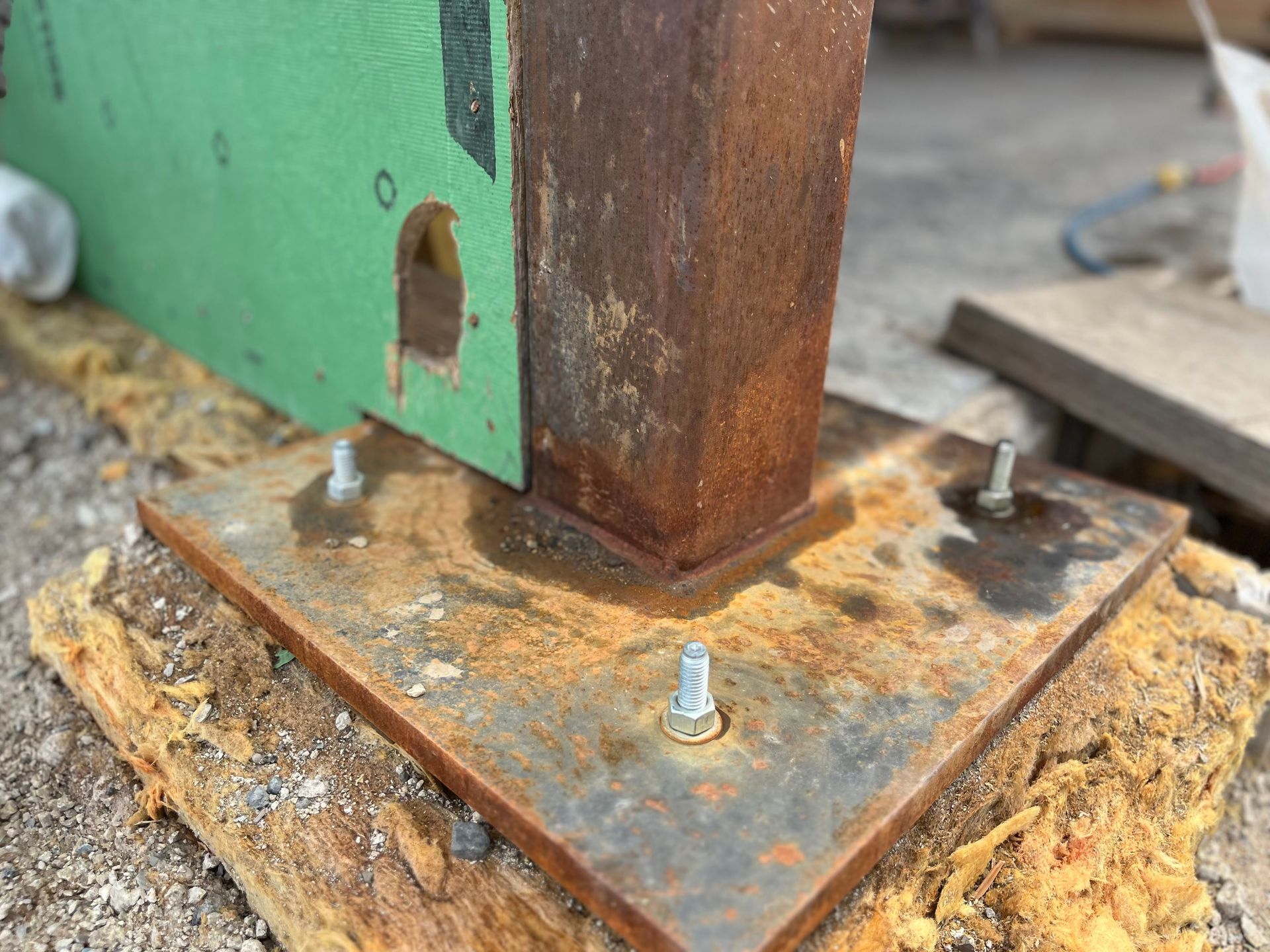 A rusty piece of metal is sitting on top of a wooden table.