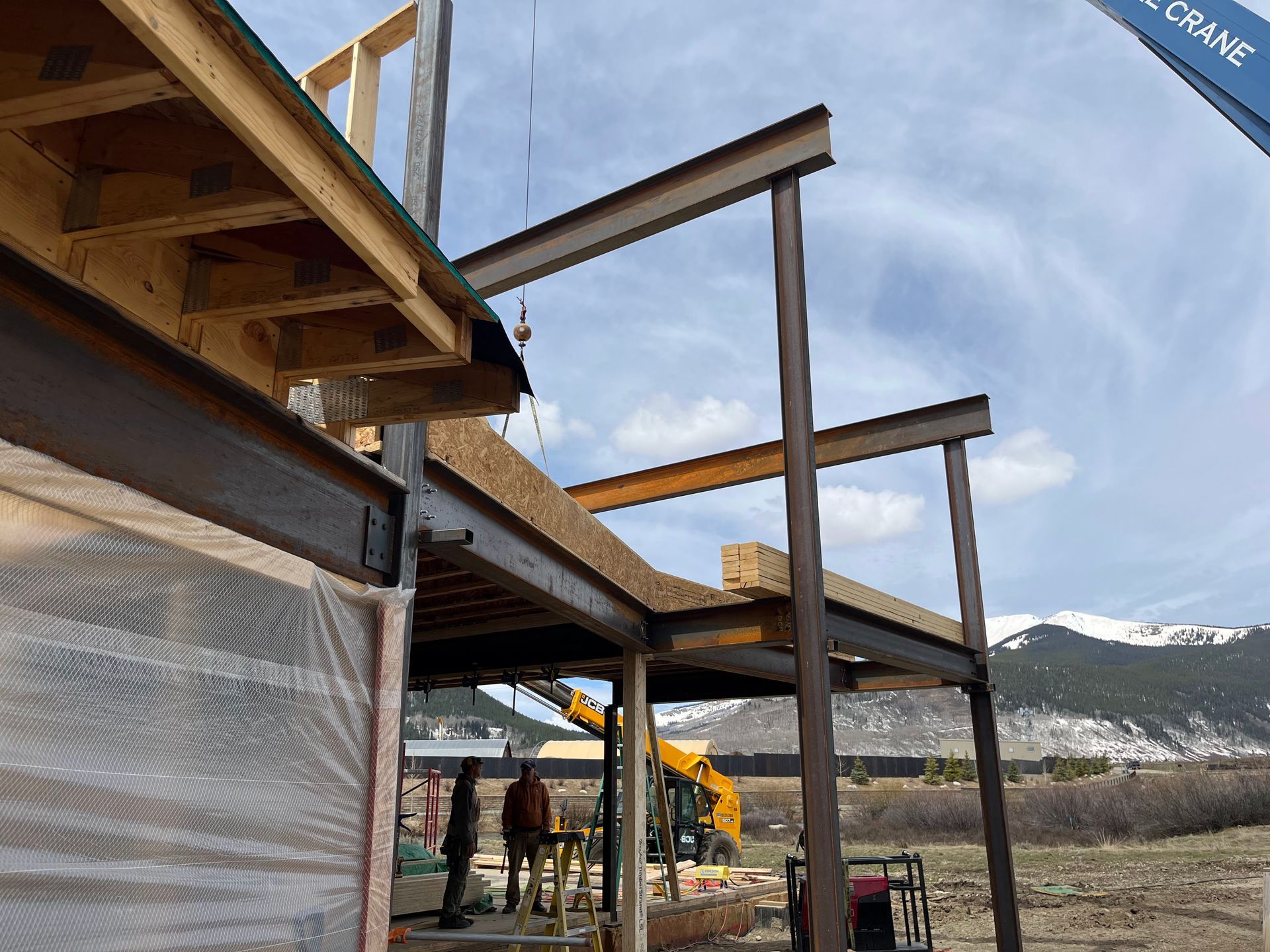 A building under construction with a crane in the background.