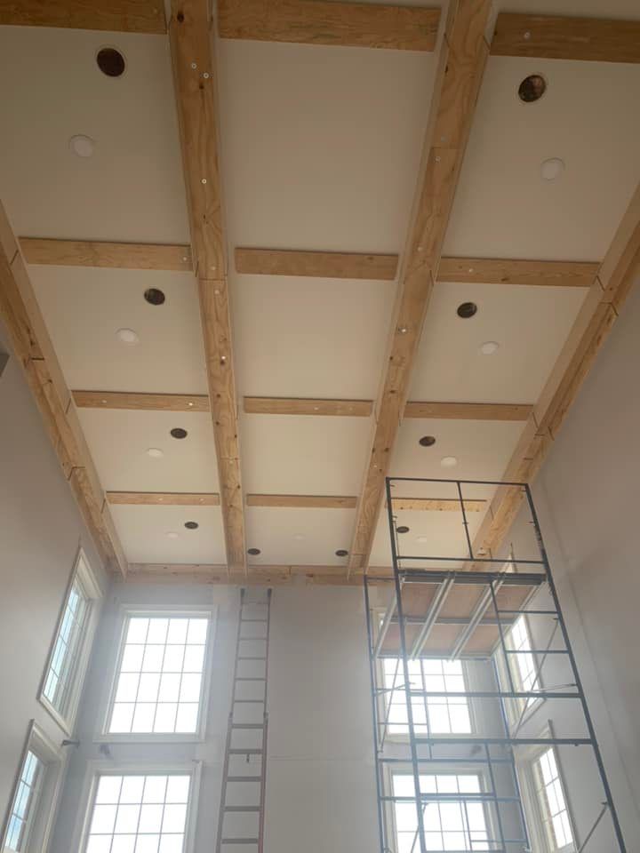 High ceiling recessed lighting installation during new construction